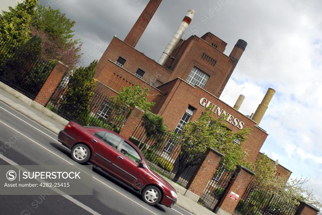 Republic of Ireland, Dublin, Guinness Brewery. A car driving past the Guinness Brewery in Dublin.
