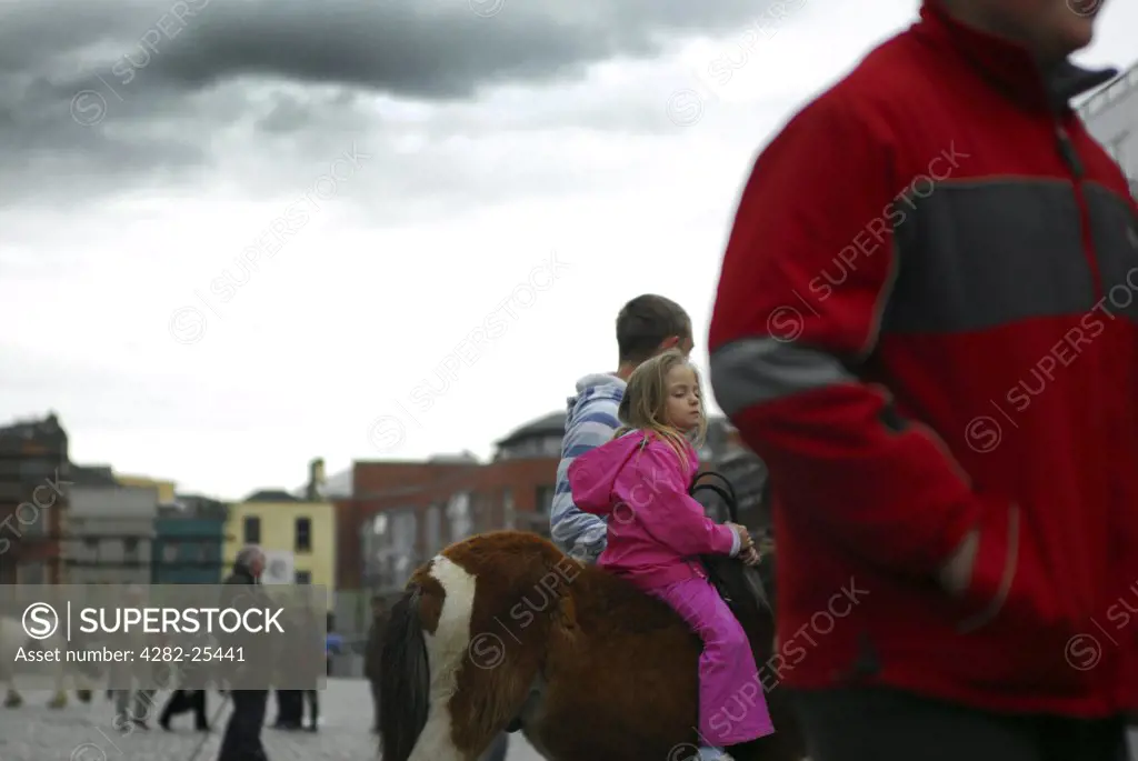 Republic of Ireland, Dublin, Smithfield Horse Market. Youngsters on horseback at Smithfield Horse Market in Dublin.
