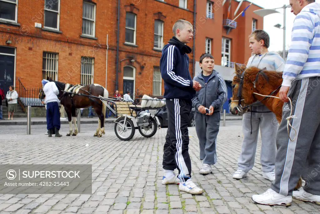 Republic of Ireland, Dublin, Smithfield Horse Market. Youngsters with the horses at Smithfield Horse Market in Dublin.