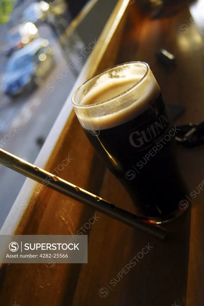 Republic of Ireland, Dublin, Temple Bar. Pint of Guinness and tin whistle at a pub in the Temple Bar of Dublin.