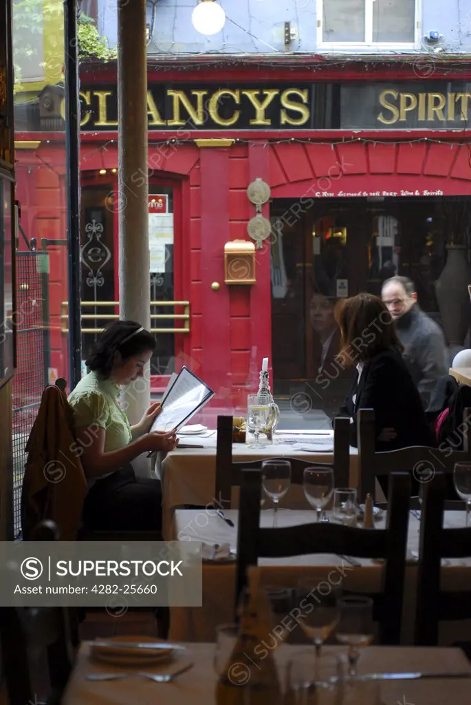 Republic of Ireland, County Cork, Cork. Women sitting in a restaurant window in Cork.
