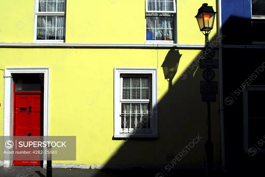 Republic of Ireland, County Cork, Central Cork. A yellow house from a street scene in central Cork.