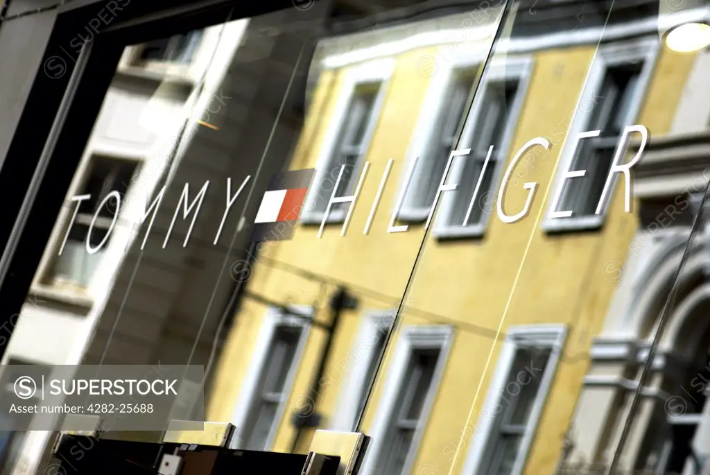 Republic of Ireland, County Cork, Central Cork. Reflections in the window of a Tommy Hilfiger shop in Cork.