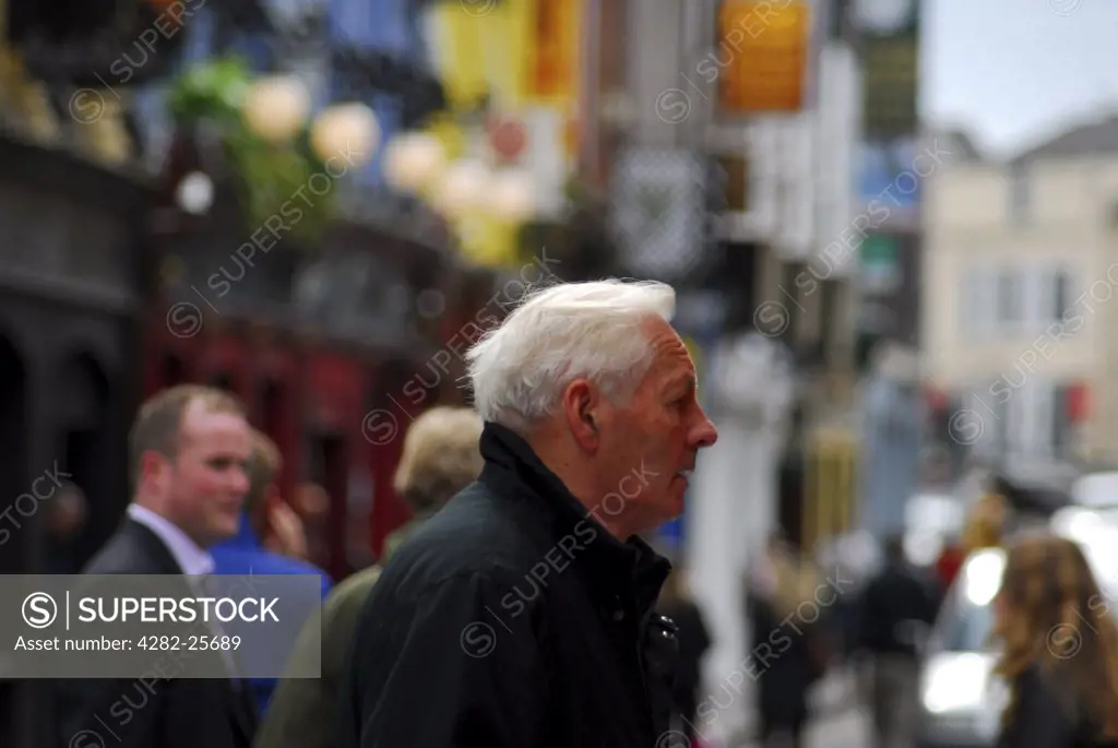Republic of Ireland, County Cork, Central Cork. Passers by in a street scene in central Cork.