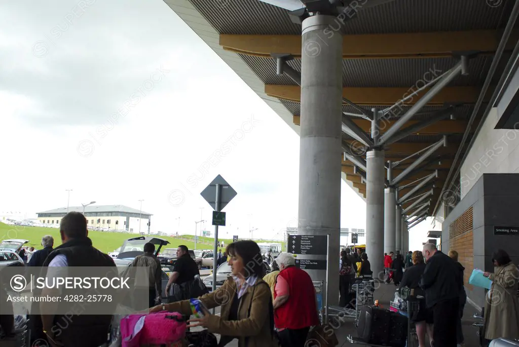 Republic of Ireland, County Cork, Cork Airport. A view of passengers outside Cork Airport.