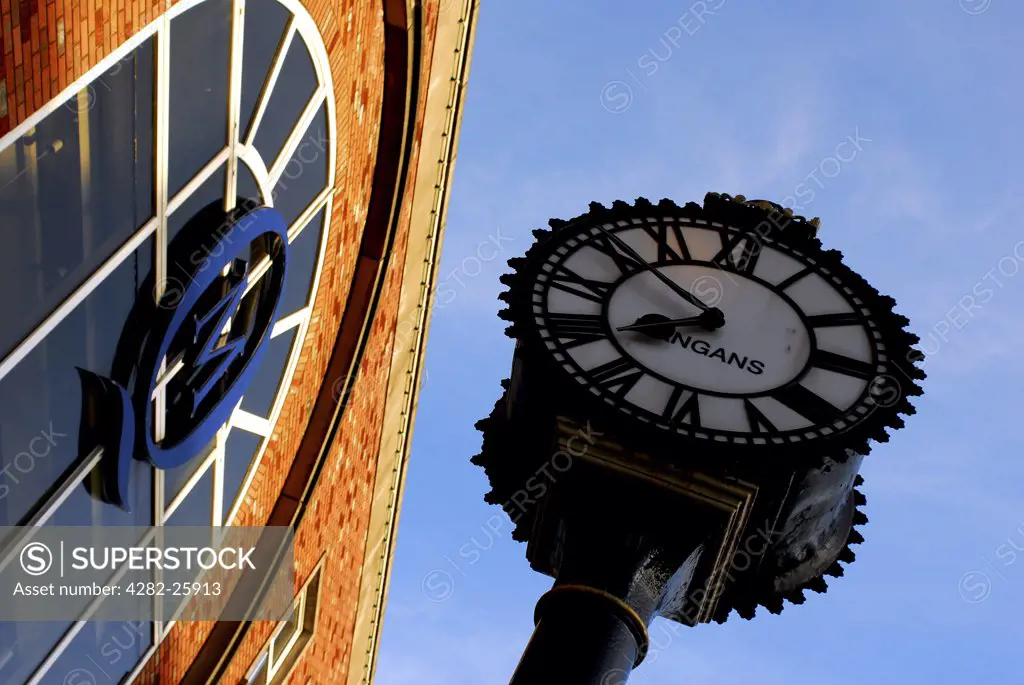 Republic of Ireland, County Cork, St Patrick's Street. A clock face and shop exterior at St Patrick's Street in Cork.