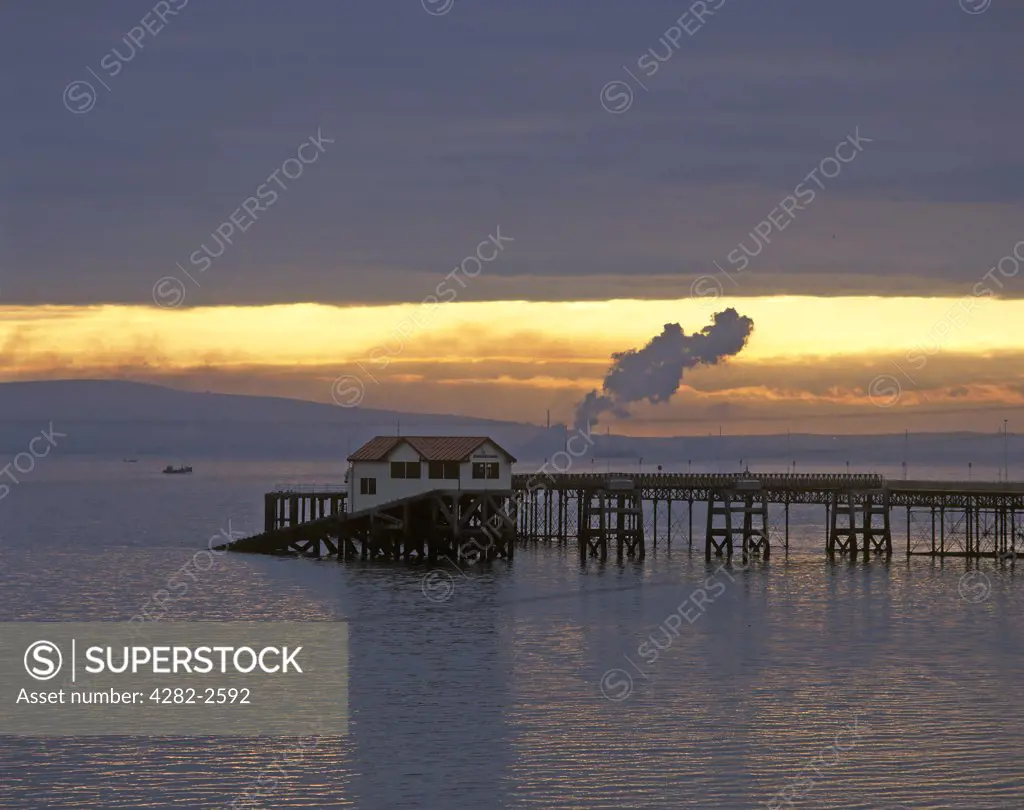 Wales, Swansea, The Mumbles. Sunrise over the Mumbles pier.