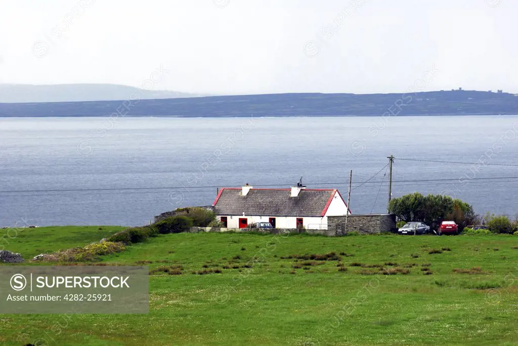 Republic of Ireland, County Clare, The Burren. A view toward a typical house in The Burren.