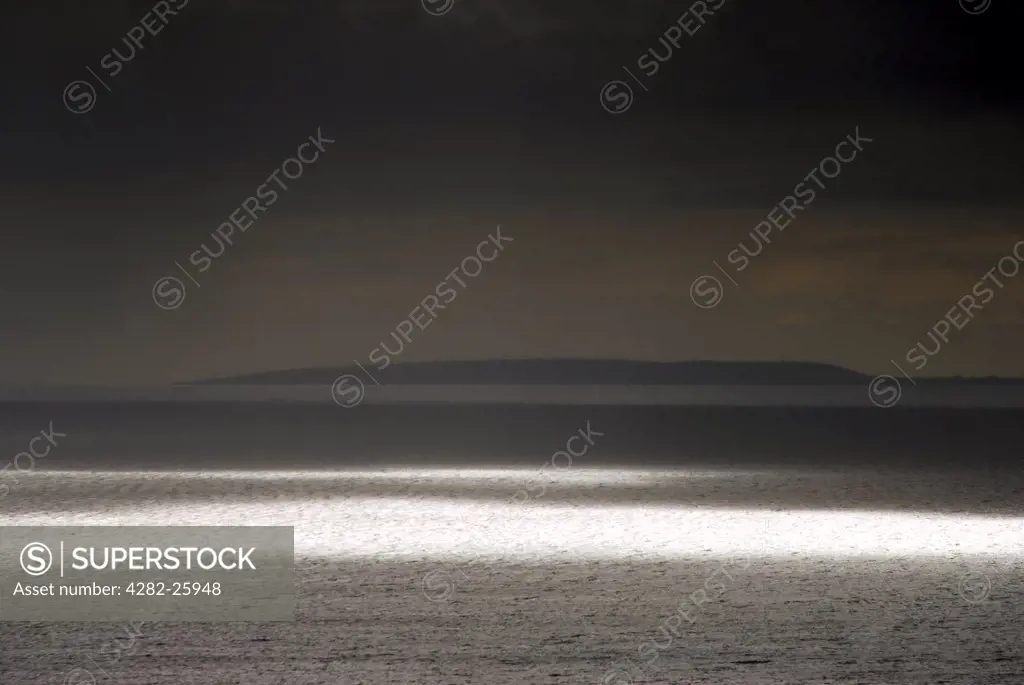 Republic of Ireland, County Clare, The Burren. Shafts of light over the Atlantic at The Burren in County Clare.