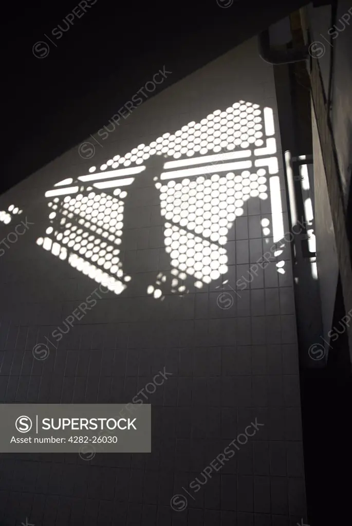 England, London, Kingston upon Thames. Shadows on a wall from people descending a flight of steps near the John Lewis store in Kingston upon Thames.