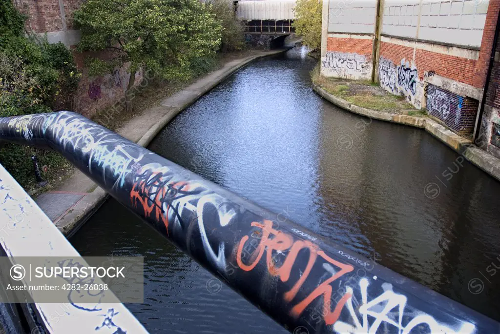 England, West Midlands, Birmingham. Grafitti adding colour to the Bordersley Junction canal in Birmingham.