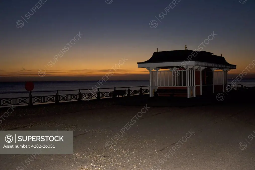 England, City of Brighton and Hove, Hove. Sunset over the English Channel from a shelter on the pier at Hove.