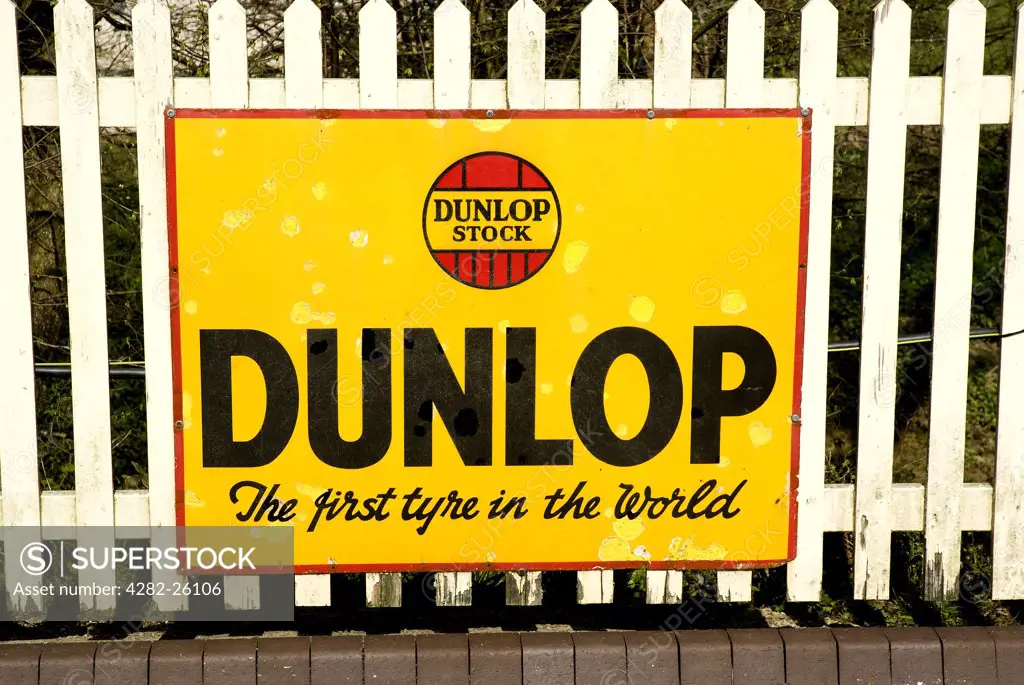 England, East Sussex, Sheffield Park. An old Dunlop advertising sign at Sheffield Park Station on the Bluebell Railway.