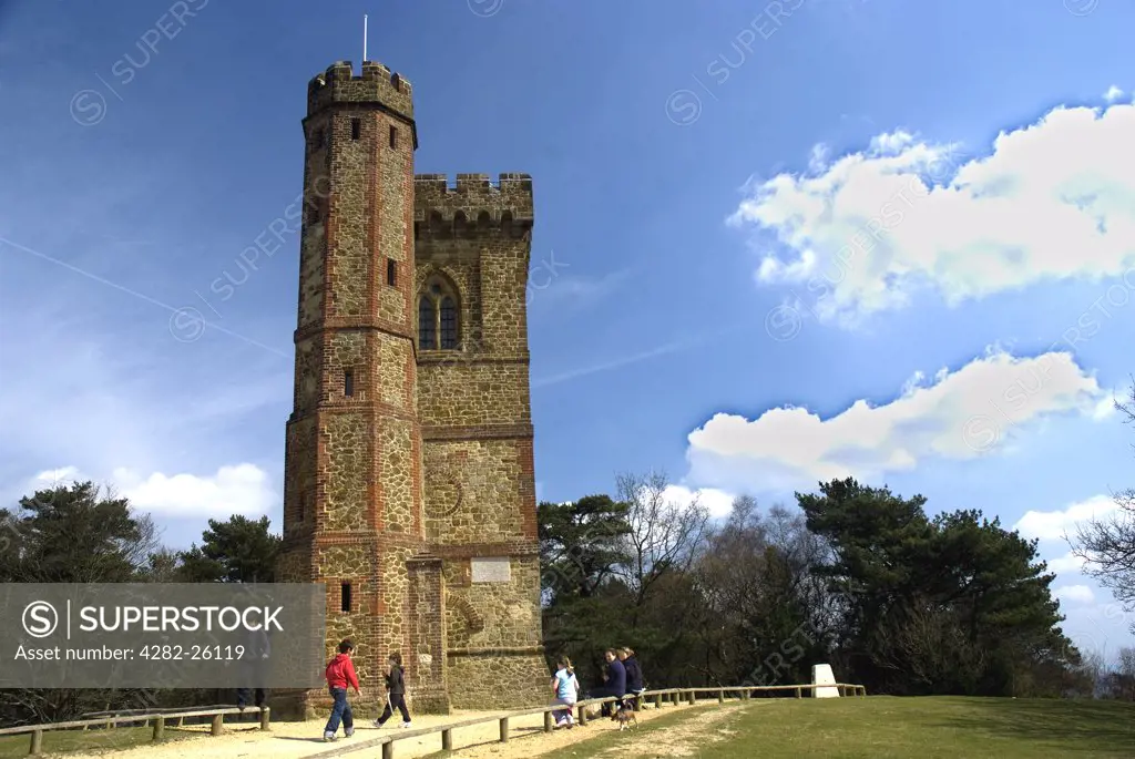 England, Surrey, Leith Hill. A family relaxing outside the gothic tower on top of Leith Hill, the highest point in South-east England.