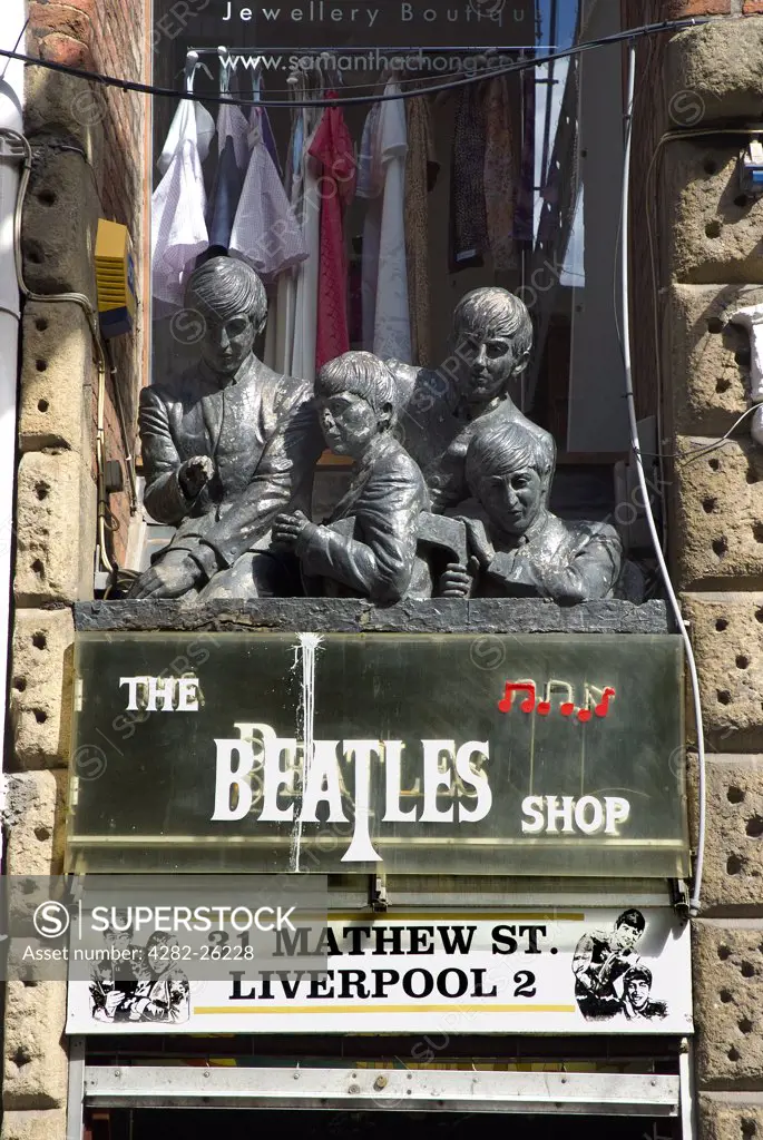 England, Merseyside, Liverpool. Statues over the entrance to The Beatles Shop on Mathew Street.