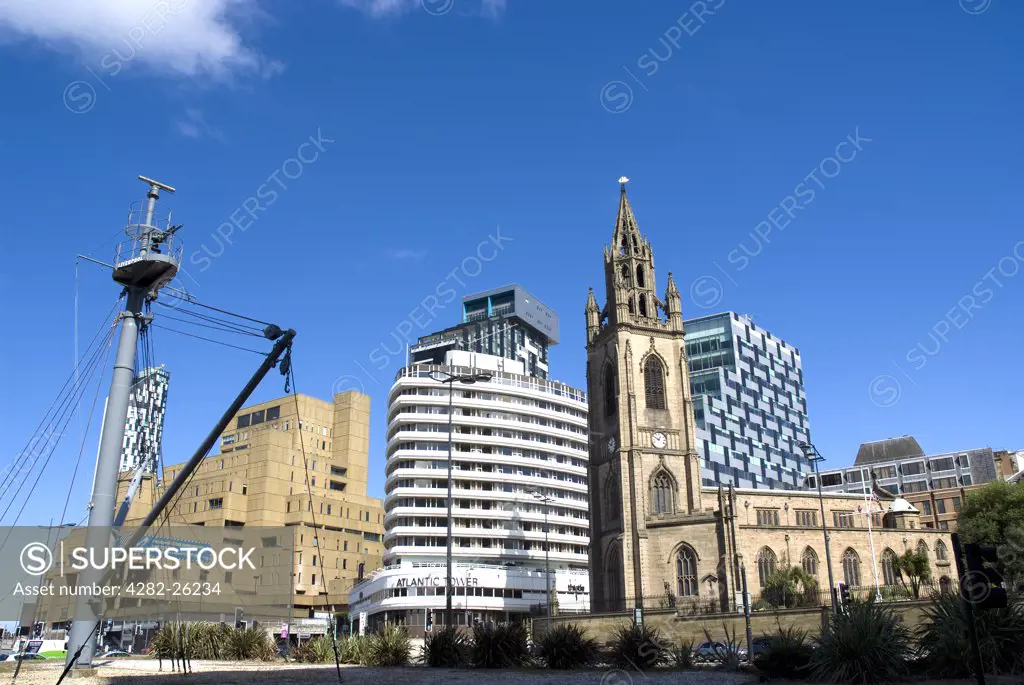 England, Merseyside, Liverpool. The Church of Our Lady and St Nicholas and The Atlantic Tower hotel on the quayside.