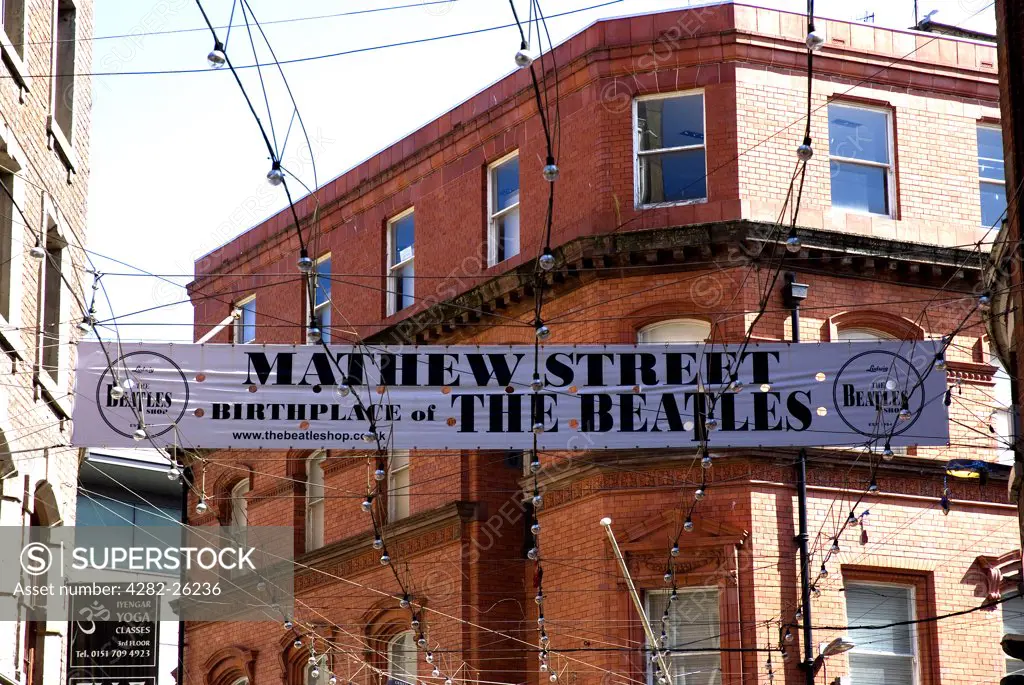 England, Merseyside, Liverpool. A banner over Mathew Street proclaiming it the birthplace of The Beatles.