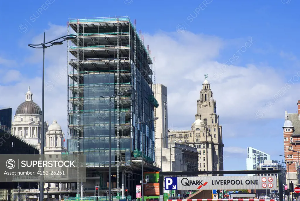 England, Merseyside, Liverpool. New building developments in Liverpool with the landmark Three Graces in the background.