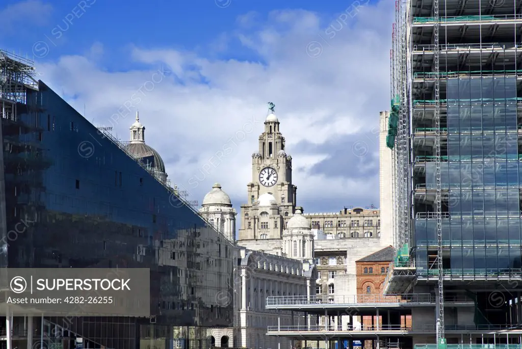 England, Merseyside, Liverpool. The Royal Liver Building between modern office and residential developments on the Pier Head.
