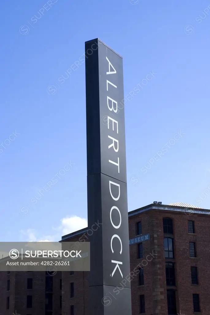 England, Merseyside, Liverpool. Sign for Albert Dock with Merseyside Maritime Museum in the background.