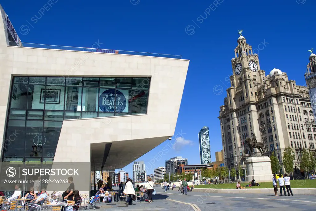 England, Merseyside, Liverpool. Beatles Story Pier Head in front of The Royal Liver Building, one of Liverpool's Three Graces.