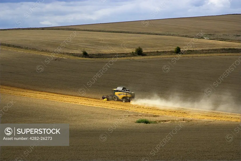 England, West Sussex, Arundel. Combine Harvester at work in a field near Arundel.