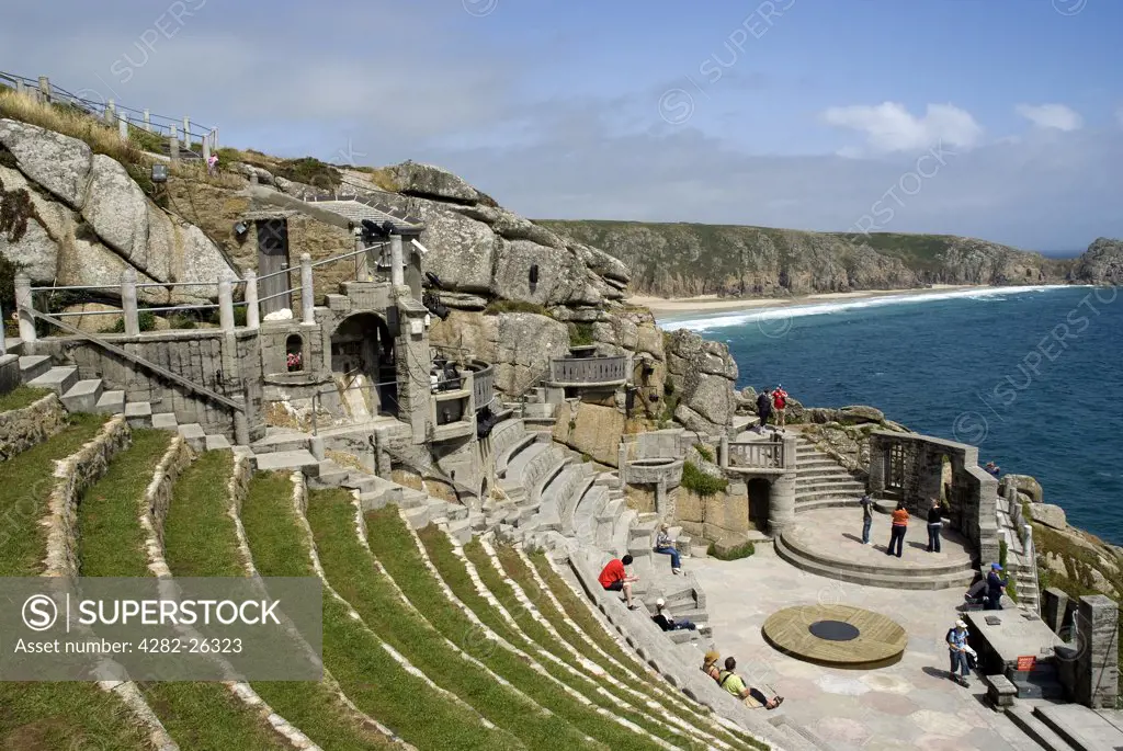 England, Cornwall, Porthcurno. A view over seating at the Minack Theatre towards Porthcurno Bay in the background.