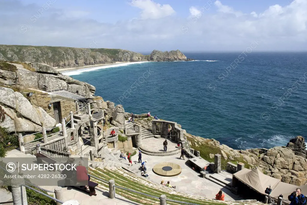 England, Cornwall, Porthcurno. A view down over the steep seating and stage at the Minack Theatre towards Porthcurno Bay and Logan Rock in the background.