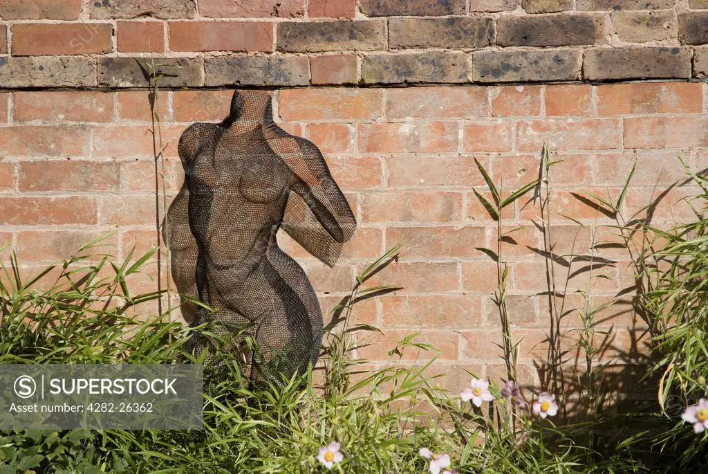 England, West Sussex, Horsham. Nikki Taylor's Female Torso sculpture in the Courtyard Sculpture Exhibition 2009 at Leonardslee Gardens.