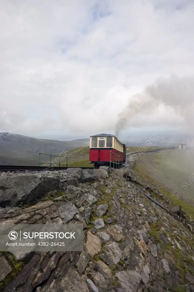 Wales, Gwynedd, Snowdon Mountain Railway. A Snowdon mountain railway steam train climbing a mountain on Snowdon. It is over 100 years old and is the only public rack railway in the British Isles.