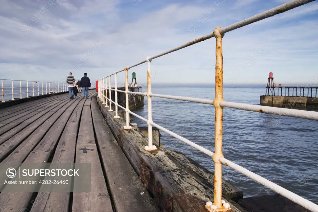 England, North Yorkshire, Whitby Pier. Railings and wooden boards along Whitby Pier.