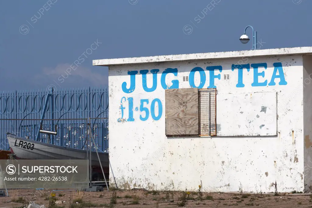 England, Lancashire, Morecambe. A sign advertising a jug of tea painted on the front of a closed cafe in Morecambe.