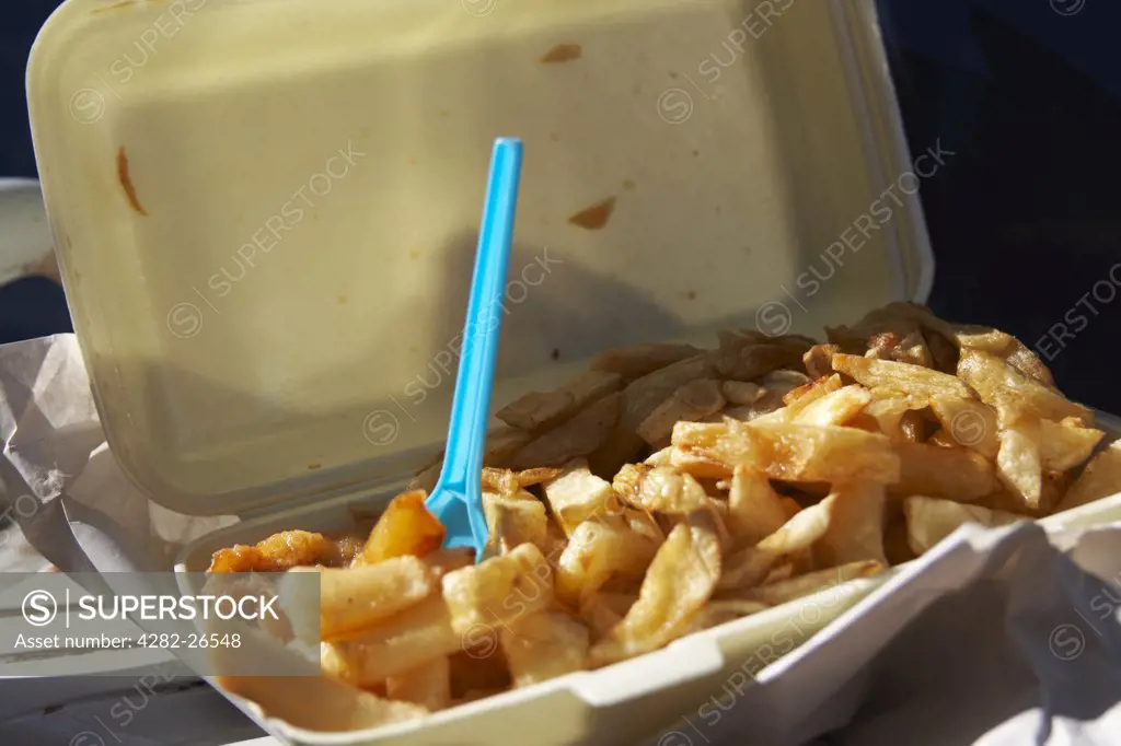 England, Lancashire, Morecambe. A close up of fish and chips in a tray on Morecambe sea front.