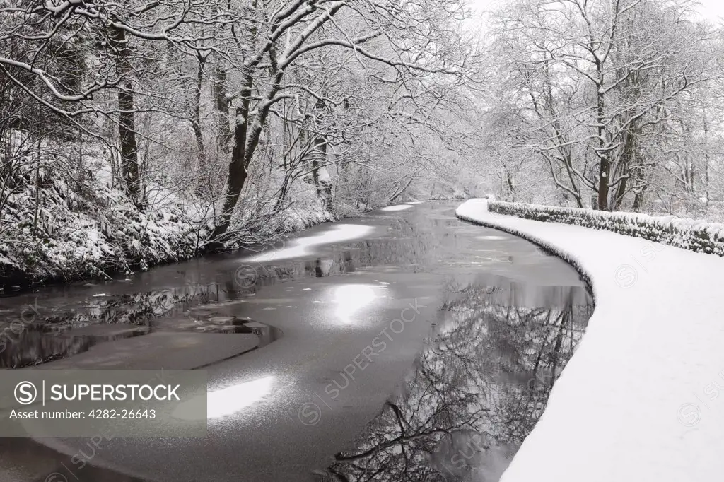 England, Lancashire, Saddleworth. Sheets of ice on the surface of the Huddersfield Narrow Canal.