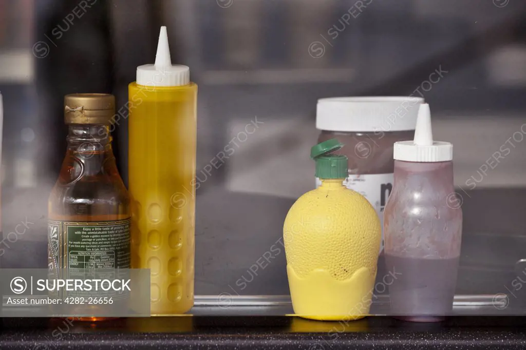 England, Lancashire, Blackpool. Sauce bottles standing in a cafe window.