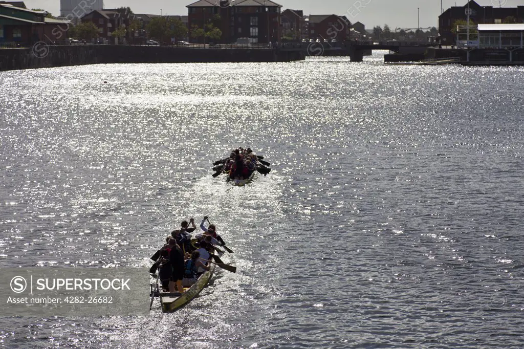 England, Merseyside, Liverpool. A Dragon boat training session in Queen's Dock.