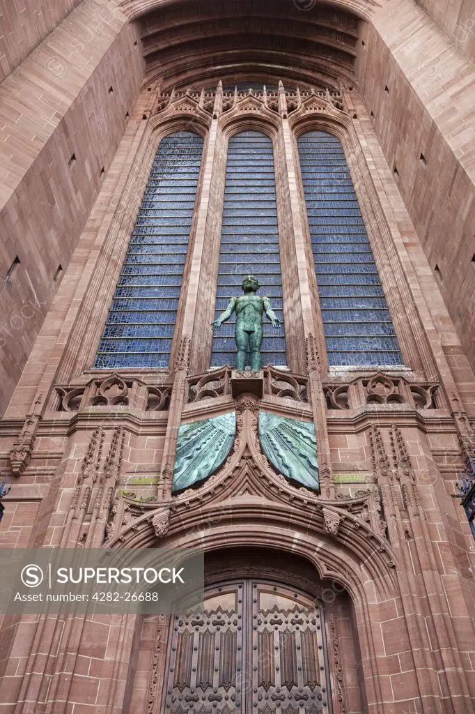 England, Merseyside, Liverpool. 'Risen Christ', a statue by Elizabeth Frink above the West door of the Anglican Cathedral.
