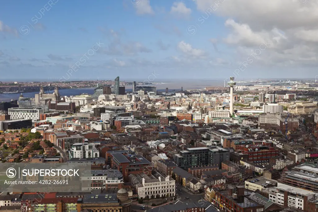 England, Merseyside, Liverpool. Aerial view over the city towards the Mersey Estuary, featuring the prominent and iconic landmarks of the Three Graces and the Radio City Tower (St. John's Beacon).