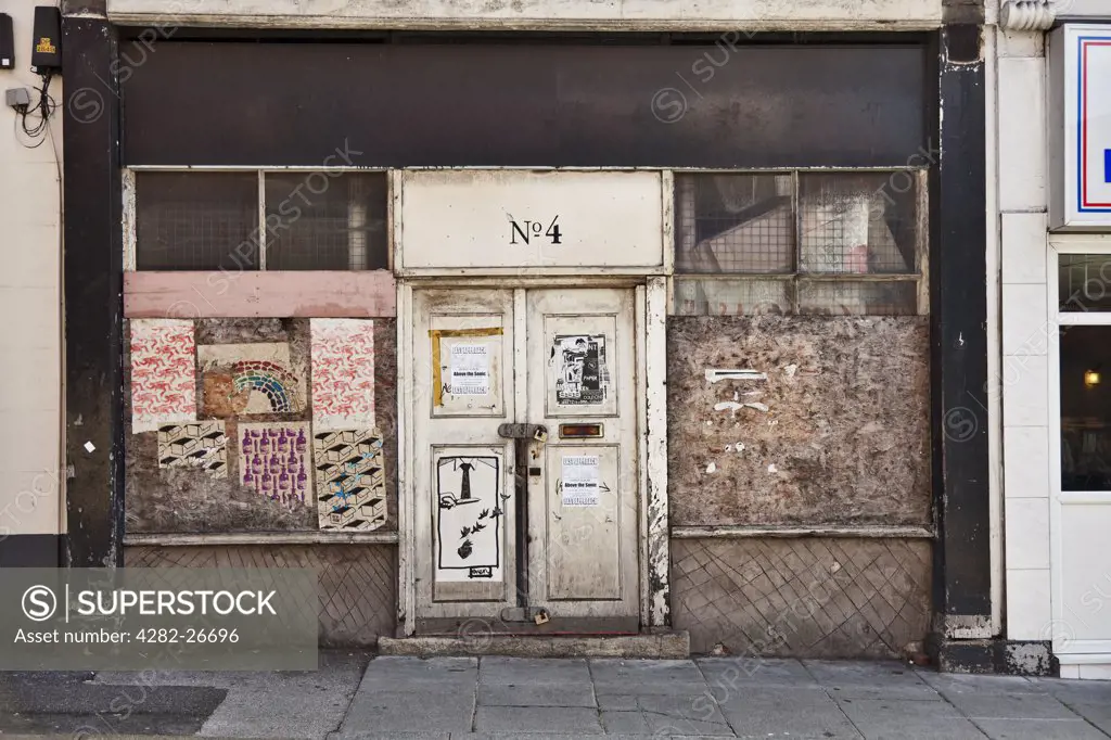 England, Merseyside, Liverpool. Boarded and locked shop front.