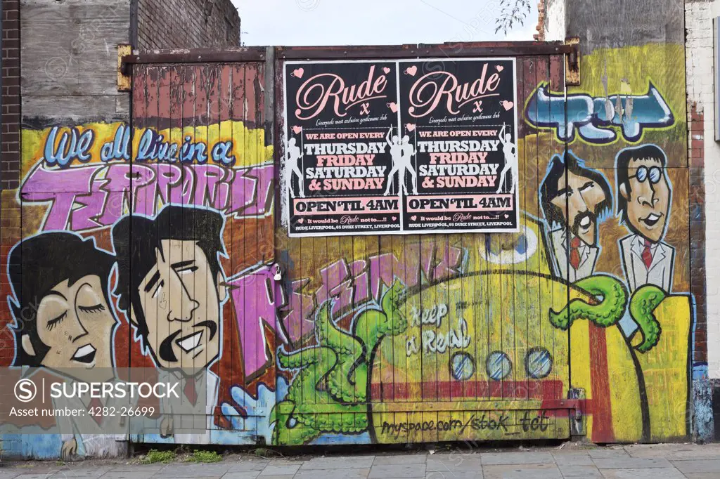 England, Merseyside, Liverpool. Grafitti sprayed across a gate featuring the Beatles.