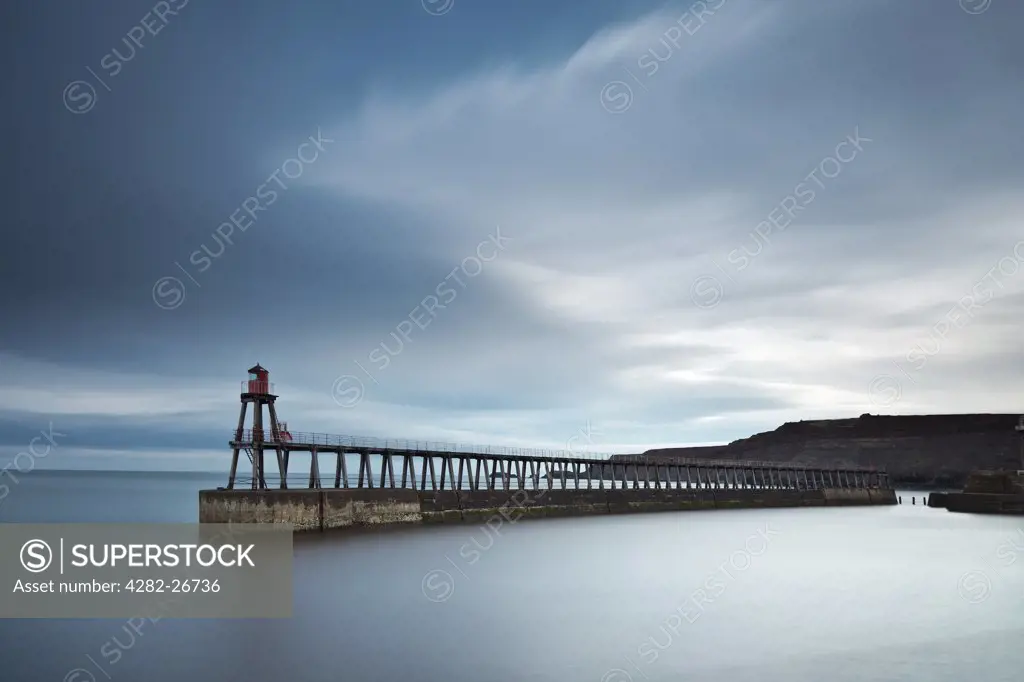 England, North Yorkshire, Whitby. Whitby East Pier Light (new) at the end of the east pier. Built as a wooden framework tower on 'legs' in 1914 after the pier was extended, the light is currently operational with an automated, fixed red light to signify port.