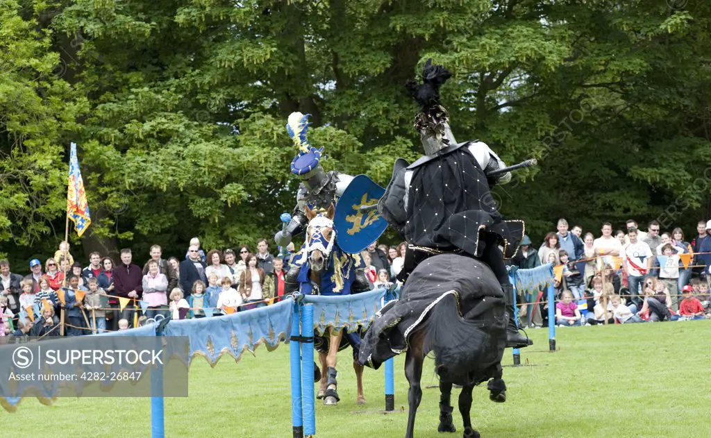 England, Essex, Castle Hedingham. Two knights battle in a jousting tournament at Hedingham Castle.