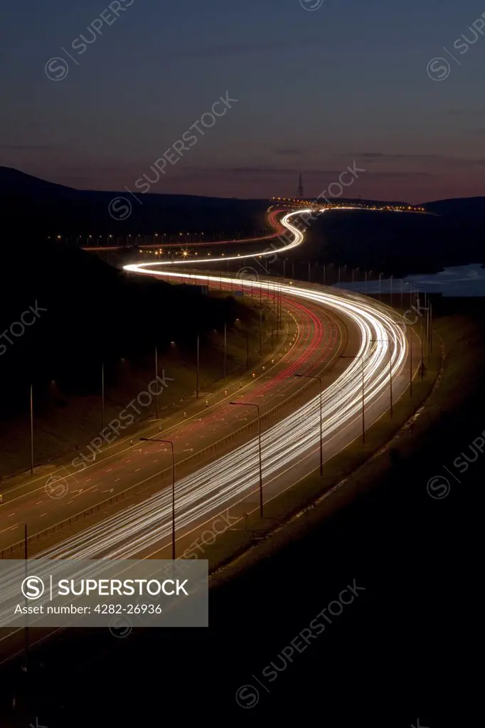 England, West Yorkshire, Huddersfield. The Trans-Pennine section of the M62 at night. It was opened by the Queen in 1971 and remains the highest motorway in the country at 1222 feet above sea level.