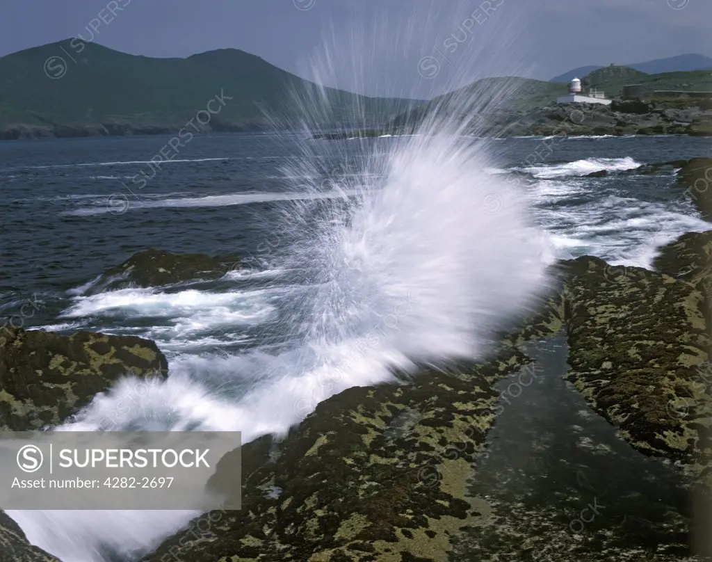 Republic of Ireland, County Kerry, Valencia Island. Waves crashing on the rocks near the lighthouse on Valencia Island.