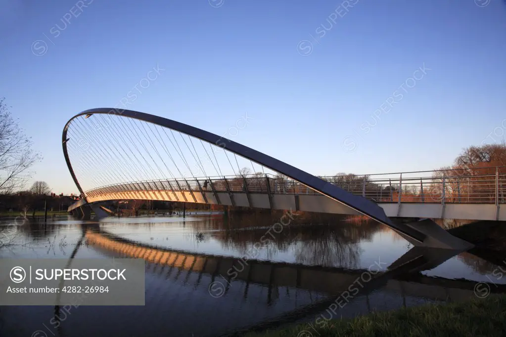 England, North Yorkshire, York. York Millennium Bridge with the River Ouse in flood.