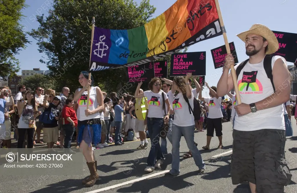 England, East Sussex, Brighton. Amnesty International members marching in the Brighton Gay Pride parade.