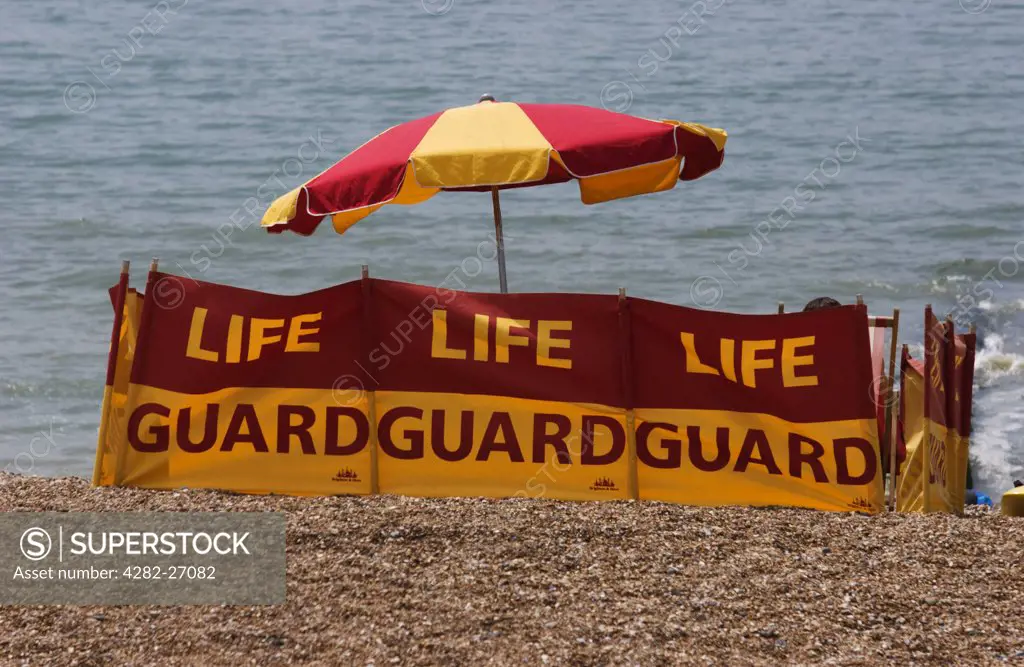England, East Sussex, Brighton. A lifeguard post on the beach at Brighton on a hot summer day.