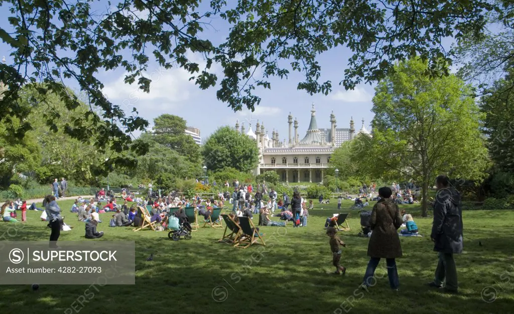 England, East Sussex, Brighton. Crowds relaxing by The Royal Pavilion in Brighton.