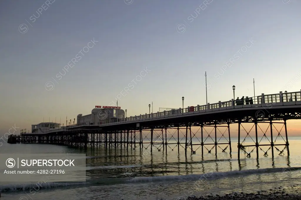 England, West Sussex, Worthing. A view toward Worthing Pier at sunset.