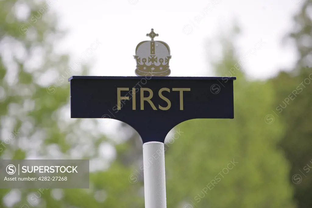 England, Berkshire, Ascot. A close up of a first sign with a crown above it at Ascot Racecourse.